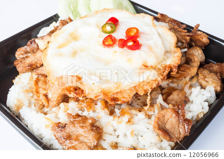 Egg fried and fried pork garlic with soy sauce topped on rice Egg fried and fried pork garlic with soy sauce topped on rice 12056966