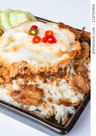Egg fried and fried pork garlic with soy sauce topped on rice Egg fried and fried pork garlic with soy sauce topped on rice 12056968