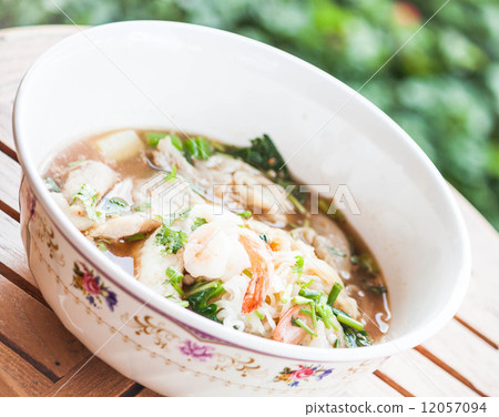 Thai noodles  with pork and shrimp in spicy soup 12057094