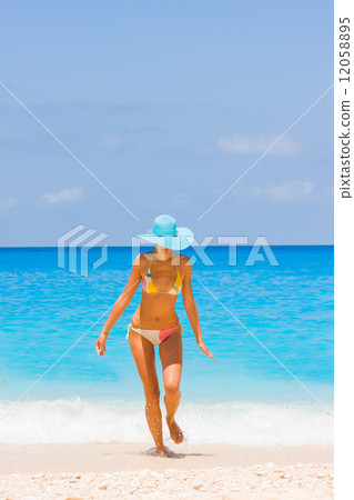 Beautiful young sexy woman by the sea in Greece 12058895