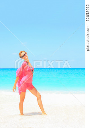 Beautiful young sexy woman by the sea in Greece 12058912