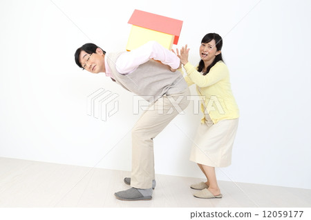 A couple carrying a house A couple carrying a house 12059177