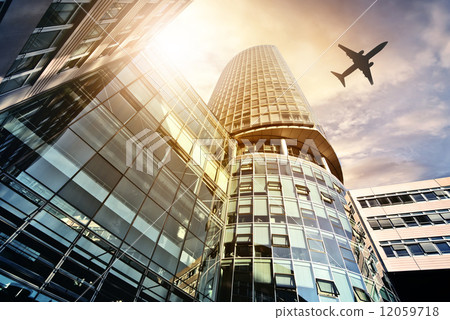 plane flying over modern office tower plane flying over modern office tower 12059718