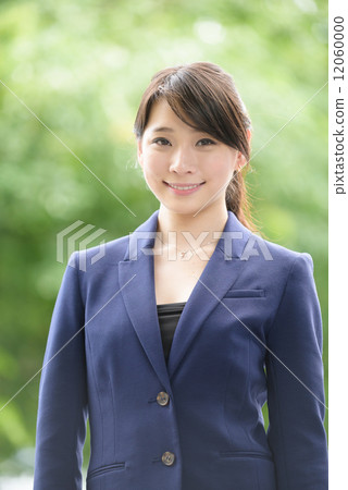 Portrait of one young successful Chinese business woman standing in front of greenery Portrait of one young successful Chinese business woman standing in front of greenery 12060000