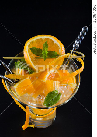 Orange Mojito over dark background Orange Mojito over dark background 12064056