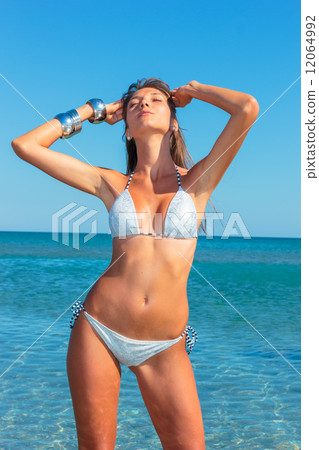 woman in bikini, outdoor on the beach 12064992