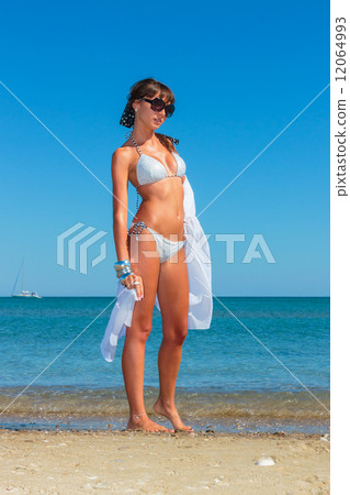 Young woman with pareo on the beach Young woman with pareo on the beach 12064993