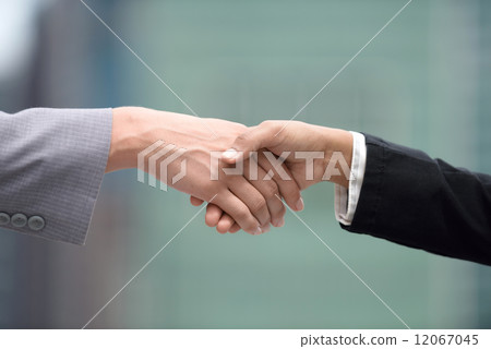 Closed up hand shot of two mixed race business women shaking hands 12067045
