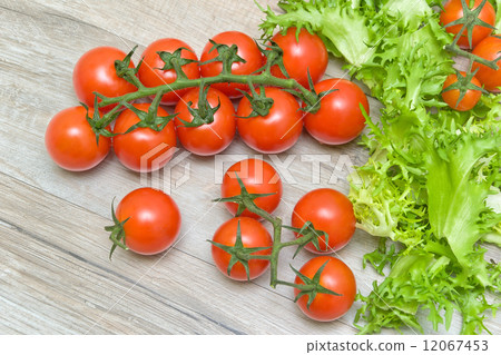 cherry tomatoes and lettuce on a wooden background 12067453
