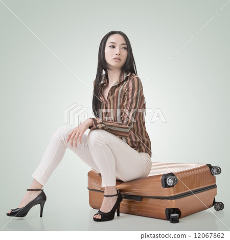 Asian woman thinking and sitting on a luggage 12067862