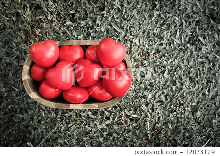 vintage style of group of hearts in wood bucket on green grass vintage style of group of hearts in wood bucket on green grass 12073129