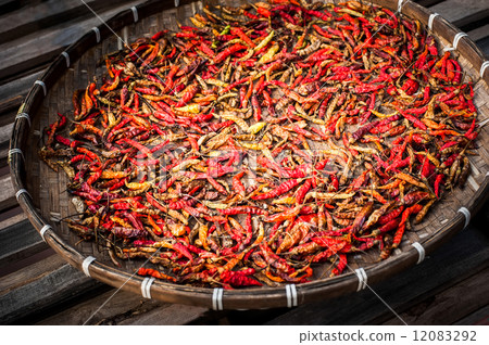 Dry red hot chili peppers wicker basket at asian market Dry red hot chili peppers wicker basket at asian market 12083292