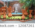 A fountain with flower pots in the Nong Nooch tropical botanic garden near Pattaya city in Thailand 12087261