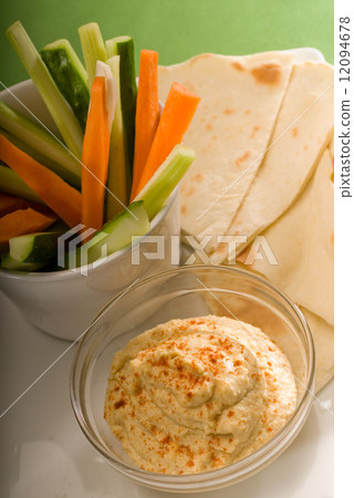 hummus dip with pita bread and vegetable