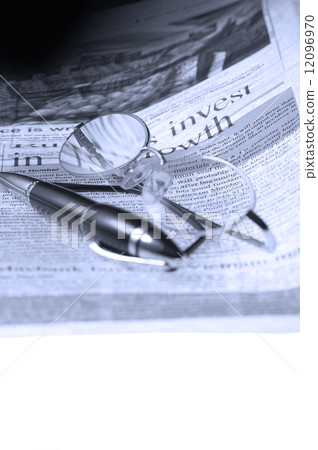 pen and glasses and newspaper 12096970