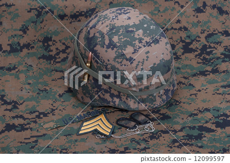 kevlar helmet with dog tags and cartridges on camouflage cover kevlar helmet with dog tags and cartridges on camouflage cover 12099597