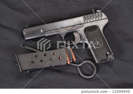 Soviet handgun on black background 12099949