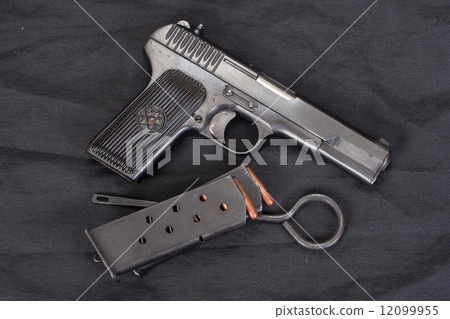 Soviet handgun on black background 12099955