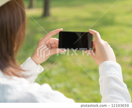 Female model shooting with smartphone 12103650