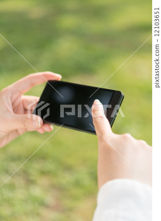 Female model to touch smartphone 12103651