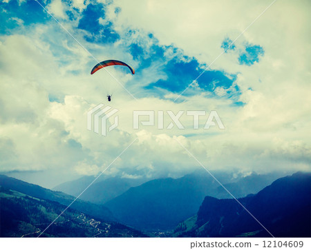 Paraplane in sky above mountains 12104609