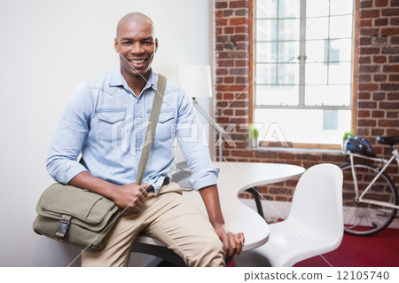 Casual businessman smiling at camera 12105740