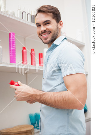 Smiling hairdresser with hair products Smiling hairdresser with hair products 12105823