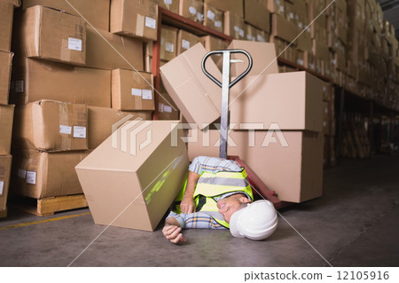 Worker lying on the floor in warehouse 12105916