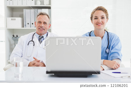 Doctor and nurse smiling at the camera 12106201