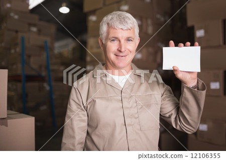 Warehouse worker holding blank paper Warehouse worker holding blank paper 12106355