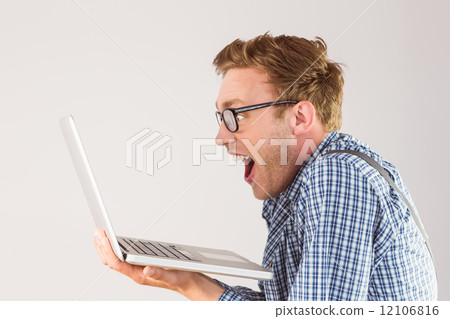 Geeky businessman using his laptop Geeky businessman using his laptop 12106816