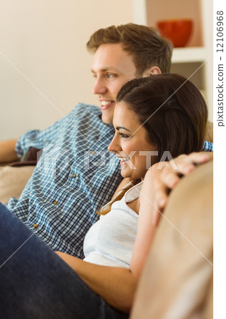 Happy young couple relaxing on the couch Happy young couple relaxing on the couch 12106968