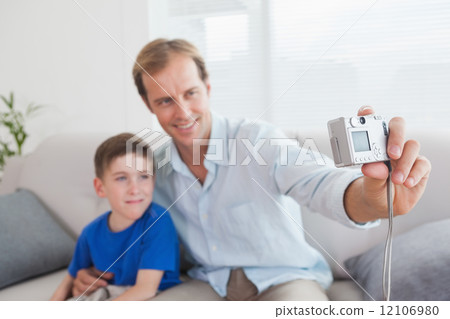 Casual father and son taking a selfie Casual father and son taking a selfie 12106980