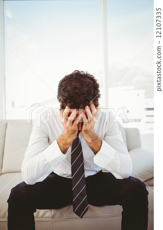 Frustrated businessman with head in hands Frustrated businessman with head in hands 12107335