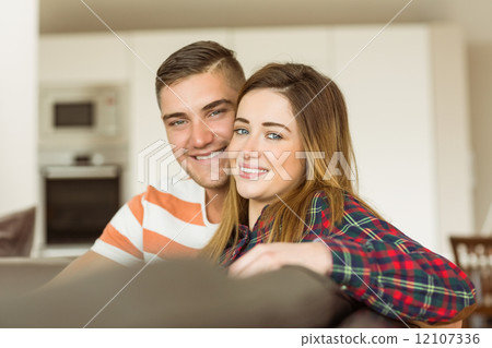Cute couple relaxing on couch 12107336