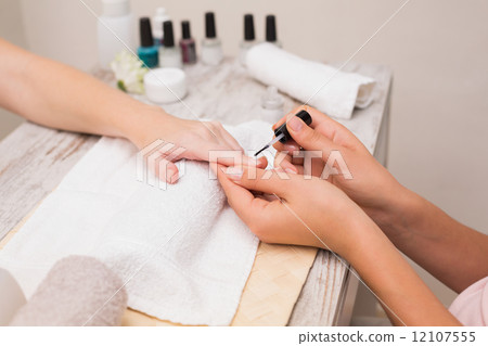 Nail technician giving customer a manicure Nail technician giving customer a manicure 12107555