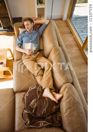 Young man napping on his couch 12107559
