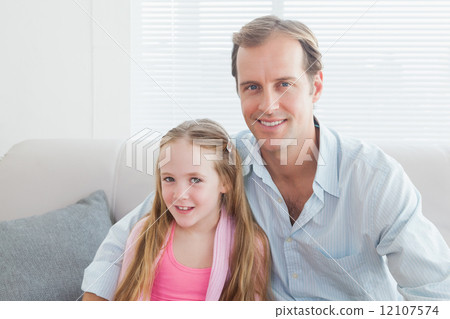 Casual father and daughter smiling at camera Casual father and daughter smiling at camera 12107574