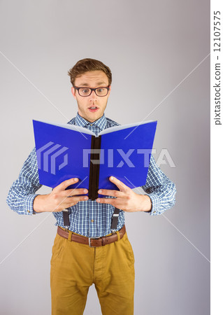 Geeky businessman reading a book Geeky businessman reading a book 12107575