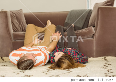 Cute couple lying on floor Cute couple lying on floor 12107967