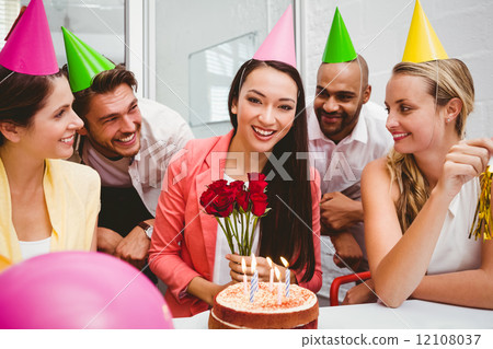 Casual business team celebrating a birthday Casual business team celebrating a birthday 12108037