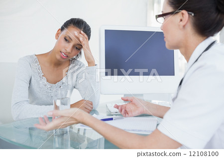 Doctor talking with upset looking patient 12108100
