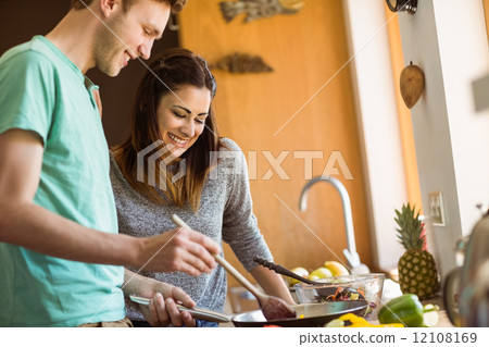 Cute couple preparing food together 12108169