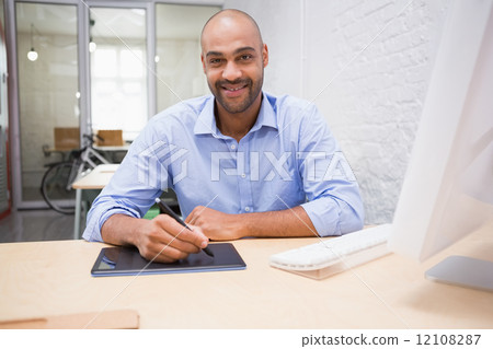 Man working at desk with computer and digitizer 12108287