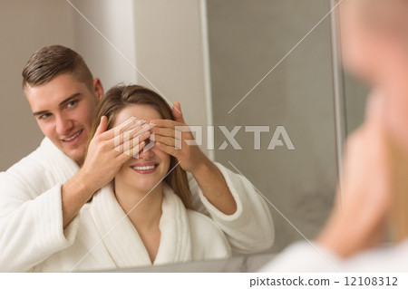 Man covering his pretty girlfriends eyes Man covering his pretty girlfriends eyes 12108312