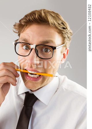 Geeky businessman biting a pencil 12108482