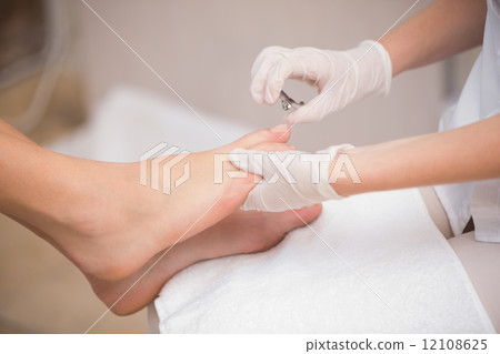 Woman getting a pedicure from beautician 12108625