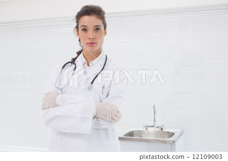 Concentrated doctor standing with stethoscope Concentrated doctor standing with stethoscope 12109003