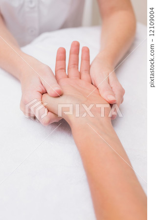 Woman getting a hand massage Woman getting a hand massage 12109004