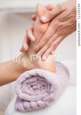 Pedicurist massaging a customers foot 12109194